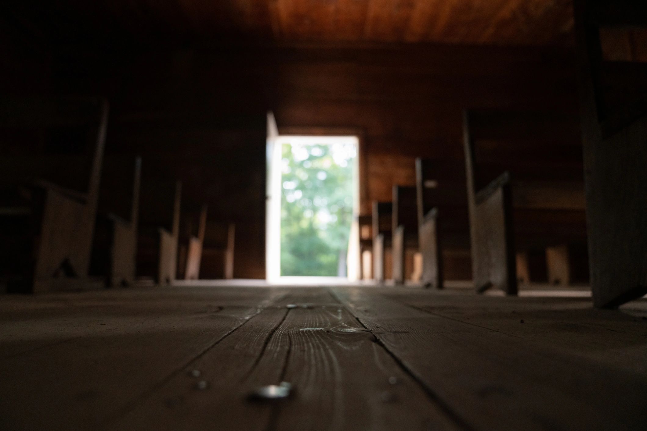 Church aisle leading through wooden pews