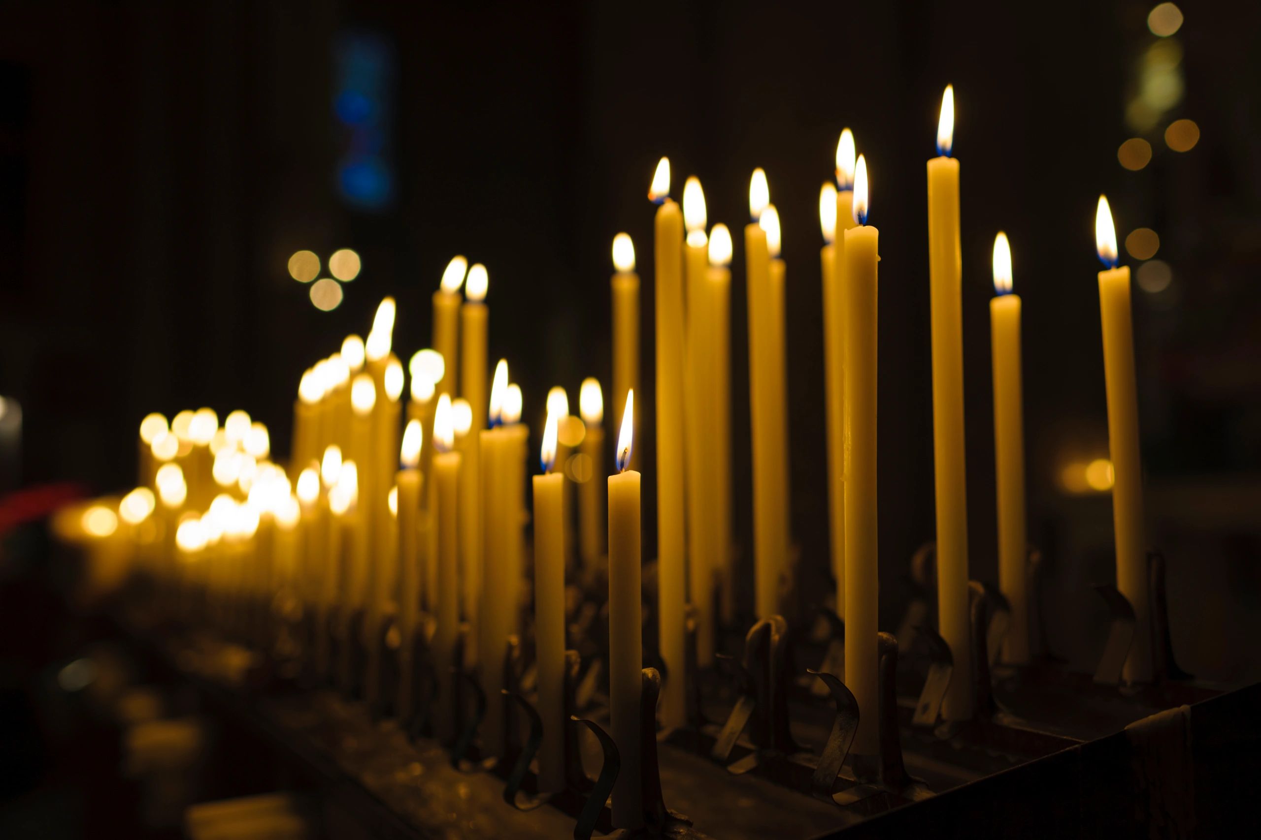 Lit candles in church interior symbolizing prayer and devotion