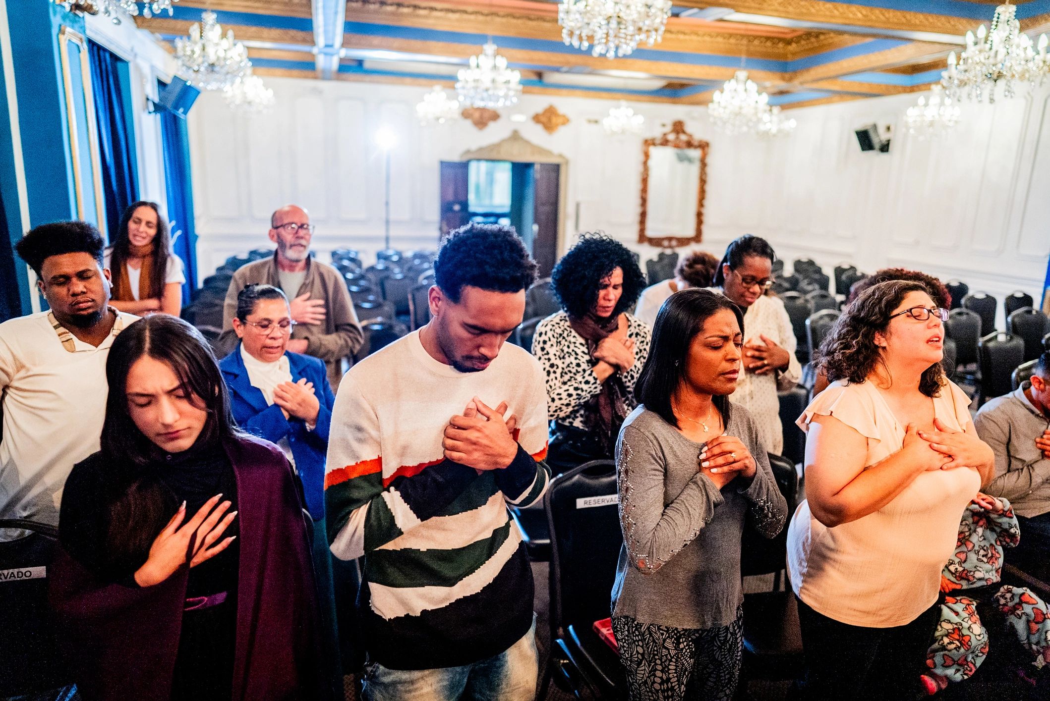 Worshippers praying together in church